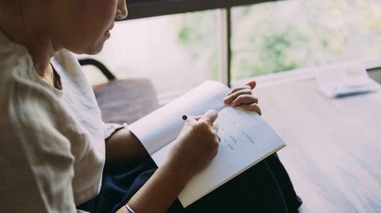 Woman writing in notebook