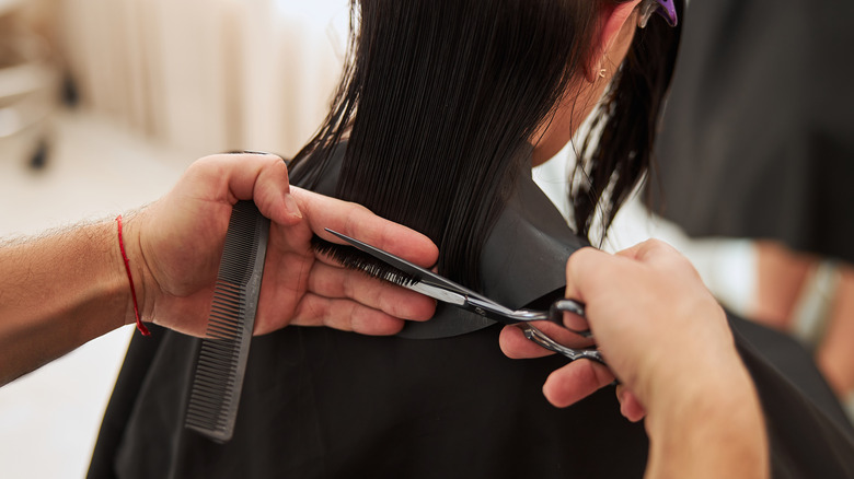 Woman getting her hair trimmed at a salon