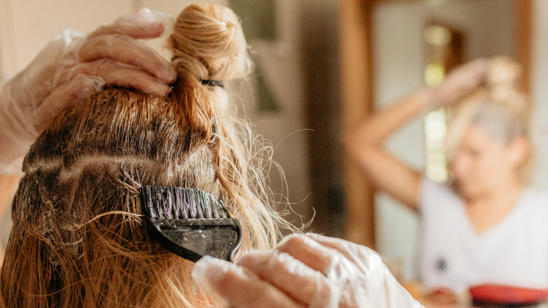 woman dying roots at home