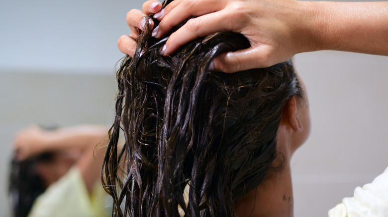 woman rinsing hair in shower