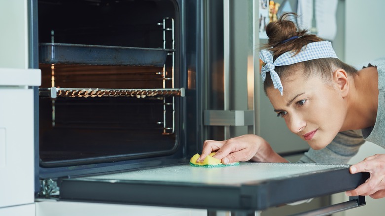 woman cleaning oven