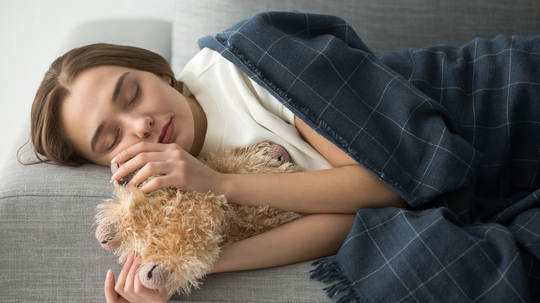 Woman sleeping with stuffed toy