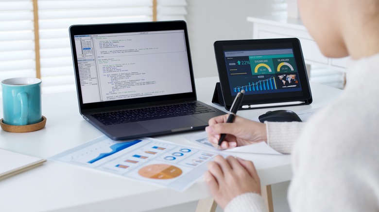 Woman working in front of two screens