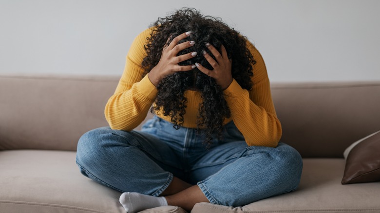 Woman crying on couch