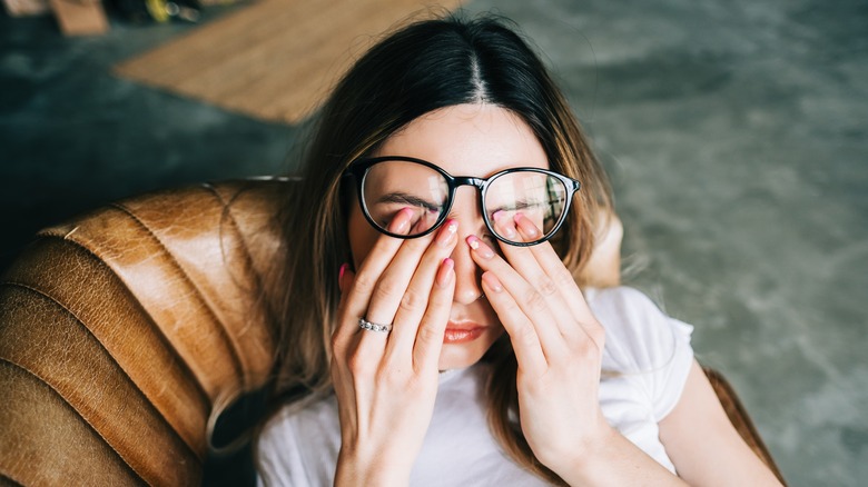 woman wiping eyes