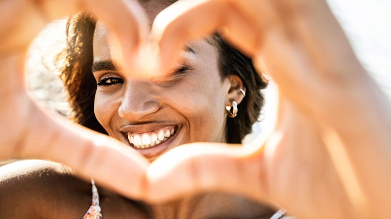 woman making heart with hands