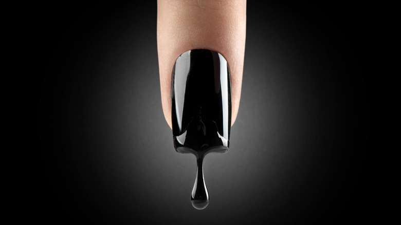 Opaque black nail polish dripping