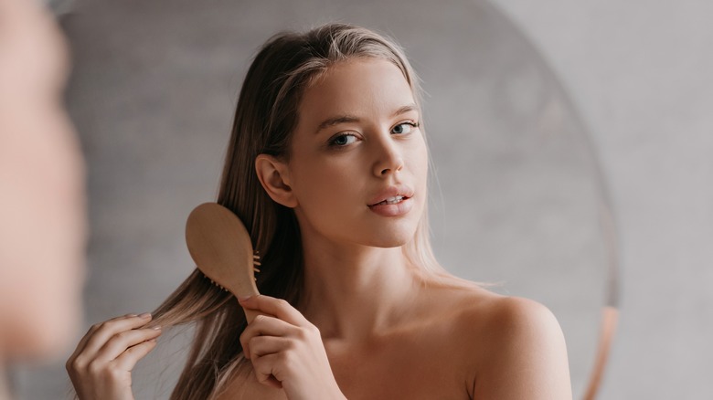 Blond combing her hair