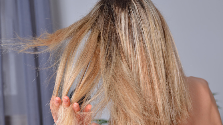 Blond styling her hair