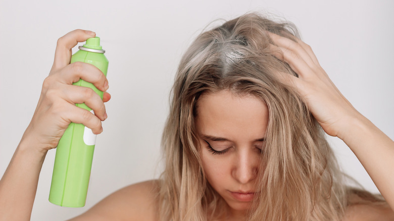 Woman using dry shampoo