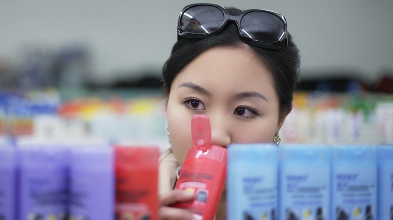 Woman smelling shampoo