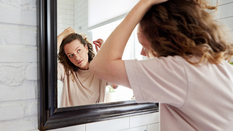 Woman using mirror