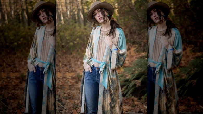 Woman in woods wearing colorful duster