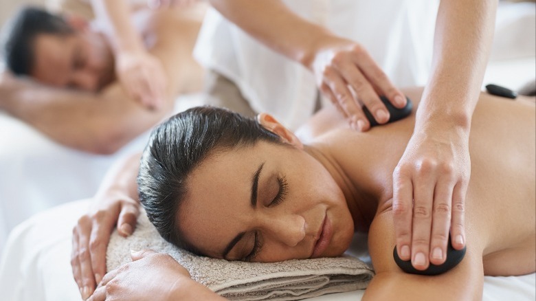 Couple getting hot stone massage