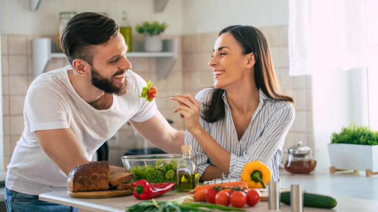couple making dinner in kitchen