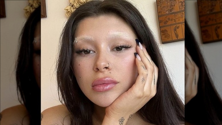 Woman wearing concealer eyebrow trend