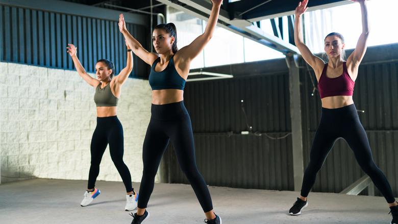 Women doing jumping jacks 