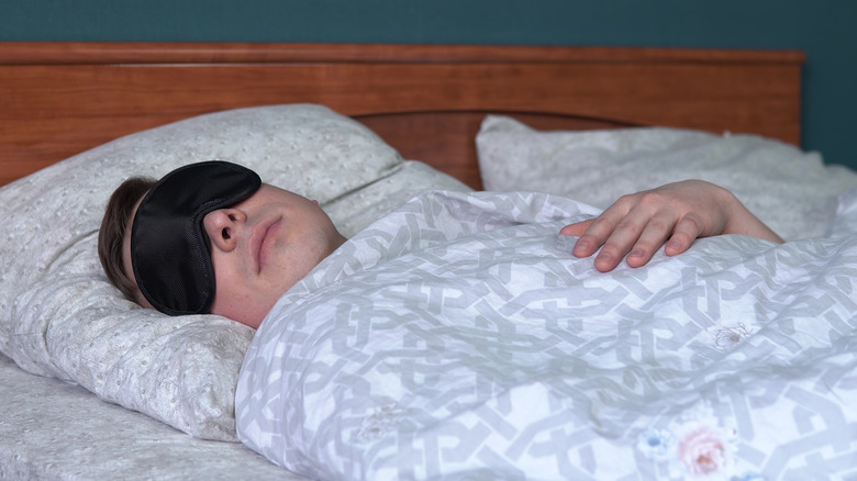 male sleeping with sleep mask