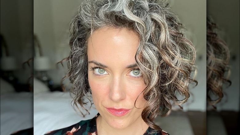 Woman with gray curly bob