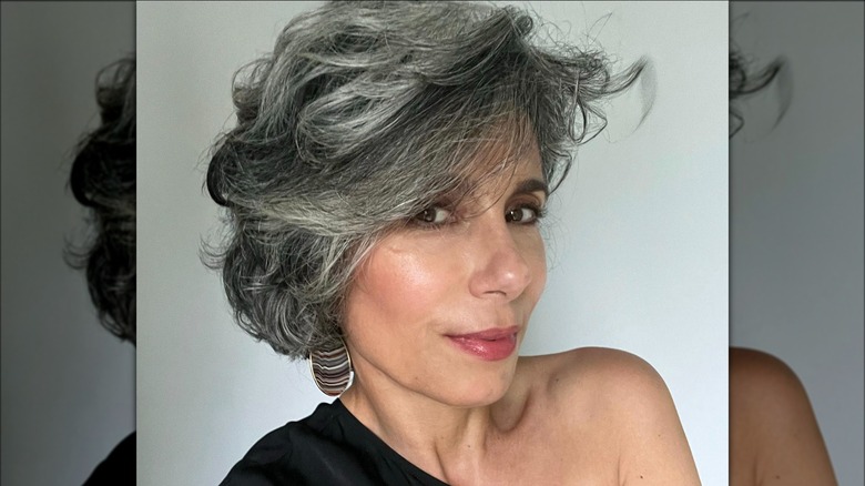 A woman with voluminous short gray hair