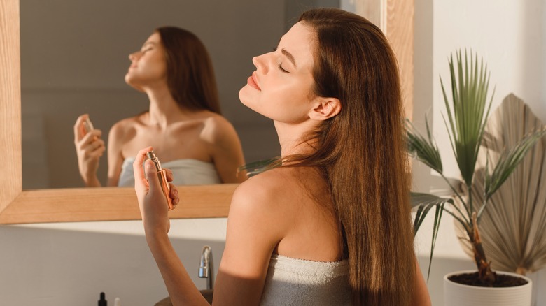 Woman spraying face mist