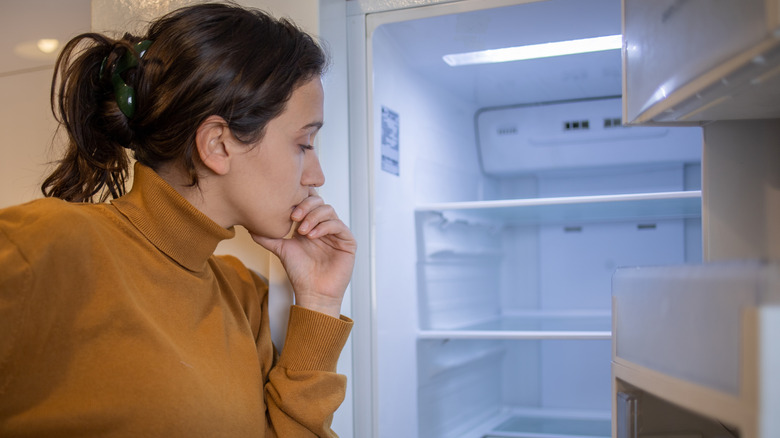 Woman and an empty fridge