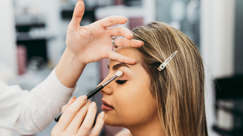 Makeup artist applying eyeshadow