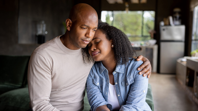 man consoling woman