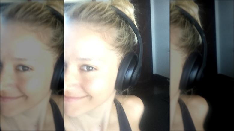 Anna Kournikova smiling in headphones