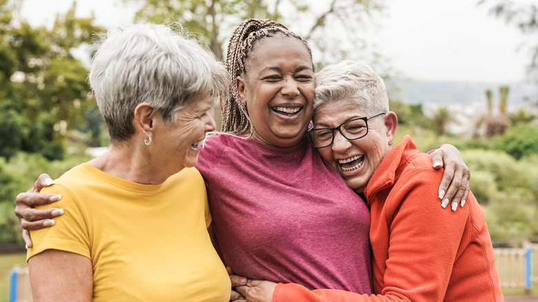 Three friends hugging 