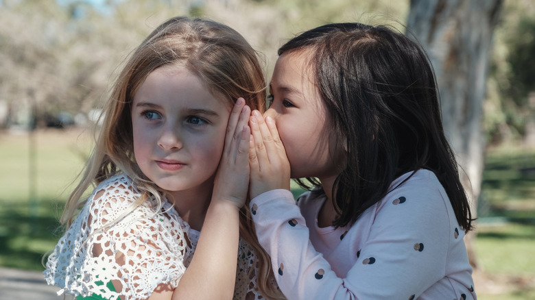 Little girls telling secrets 