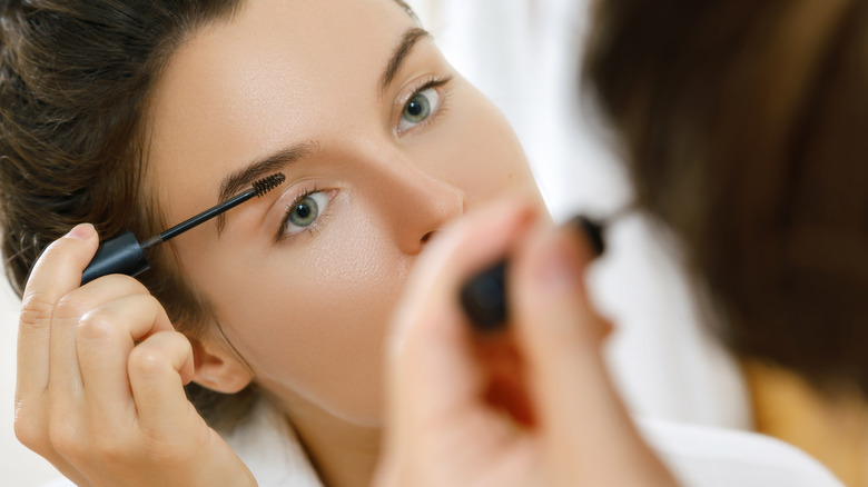 Woman applying brow gel