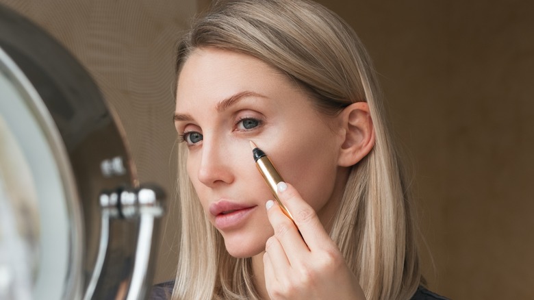 woman applying makeup