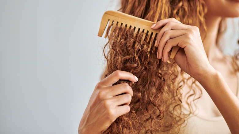 person combing dry hair