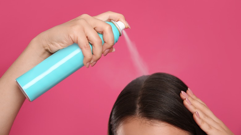 person using dry shampoo