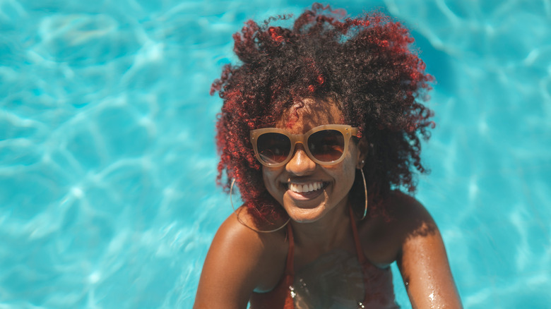 woman curly hair in pool