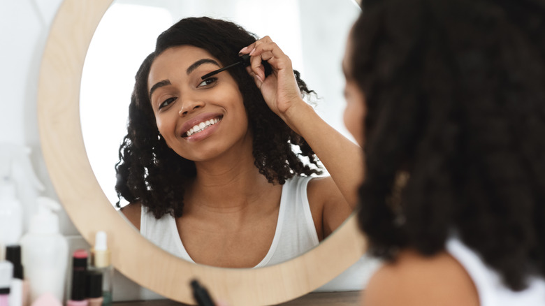 Woman applying mascara