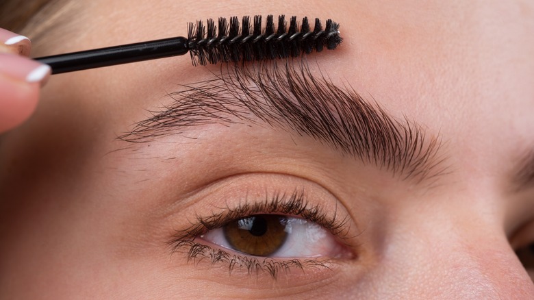 Woman shaping her eyebrows