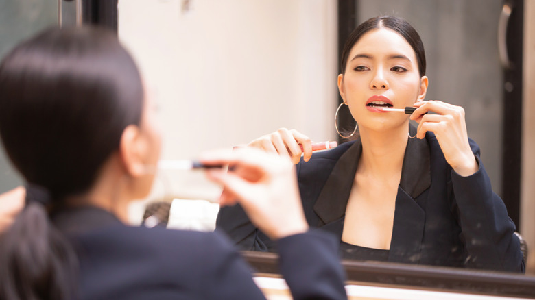 Woman applying lip product