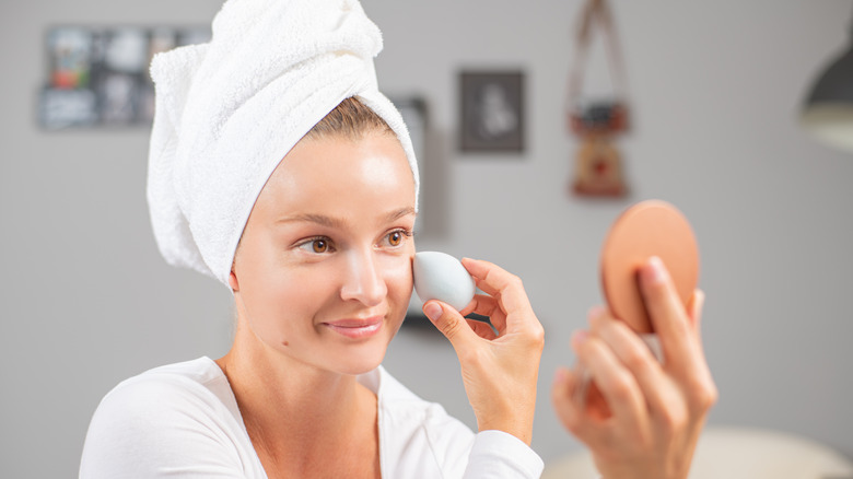 Woman applying under-eye makeup