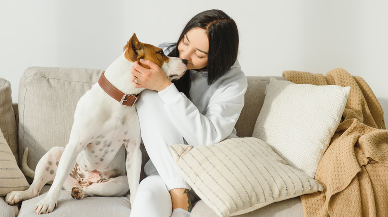 Woman kissing her dog's nose 