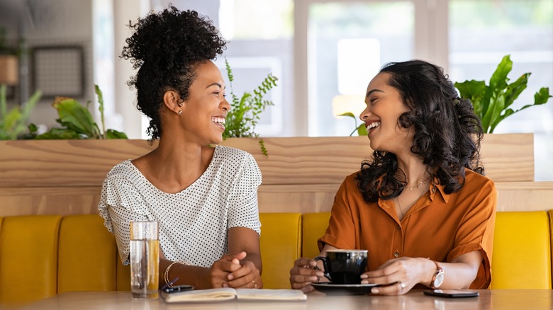 Two friends having coffee together 