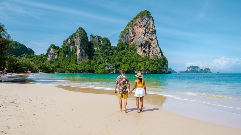 Couple walking along the beach 