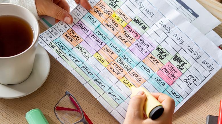 Person making a color-coded schedule 