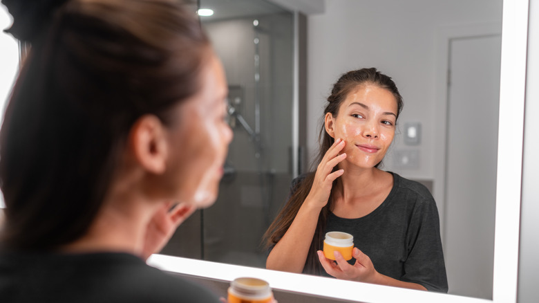 Woman applying face mask