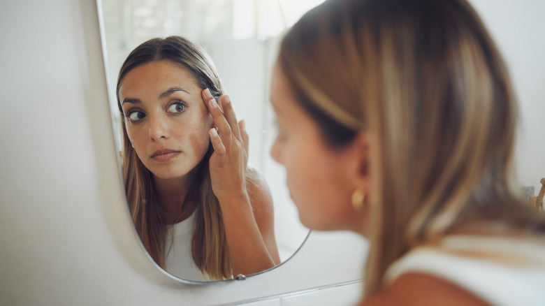 Woman looking in mirror