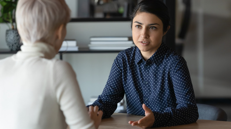 woman talking to therapist across table