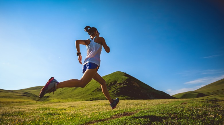 Woman running in field 