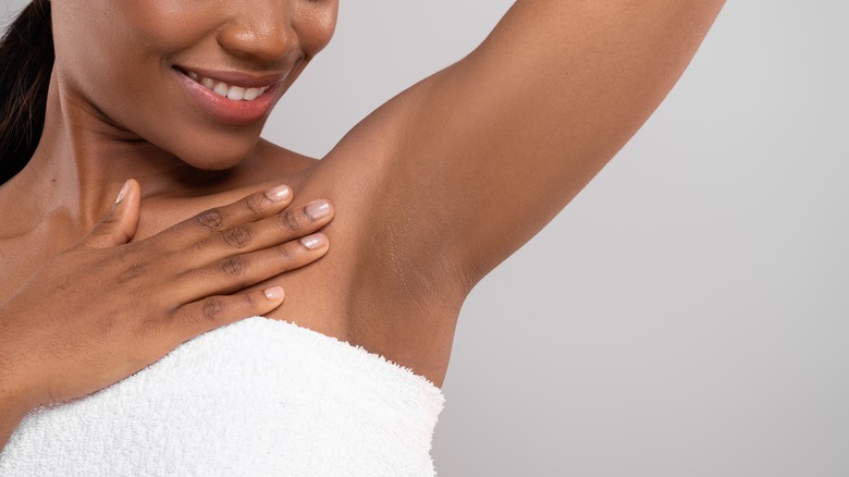 A woman inspecting her armpits