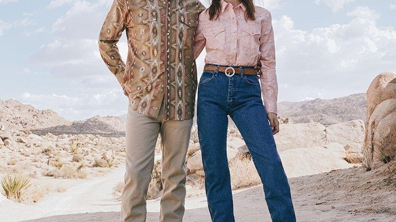 Two people in desert wearing jeans